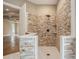 Spa-like shower with stone tile walls and a rain shower head at 1608 Golden Creek Sw Ct, Conyers, GA 30094