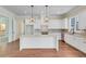 Bright kitchen featuring white cabinets, granite countertops, and a large island at 929 Hilltop Park Ct, Dacula, GA 30019