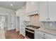 Modern kitchen with white cabinets, granite countertops, and stainless steel appliances at 929 Hilltop Park Ct, Dacula, GA 30019