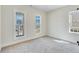 Bright bedroom with neutral carpeting and three large windows at 929 Hilltop Park Ct, Dacula, GA 30019