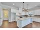 Modern kitchen with white cabinets, granite island, and stainless steel appliances at 929 Hilltop Park Ct, Dacula, GA 30019