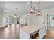 Open concept kitchen and living area with hardwood floors and a large island at 929 Hilltop Park Ct, Dacula, GA 30019
