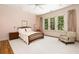 Peaceful bedroom with hardwood floors and a sitting area at 4660 Jett Rd, Atlanta, GA 30327