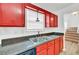 Red kitchen cabinets, stainless steel appliances, and double sink at 1804 Barrington Overlook, Marietta, GA 30066