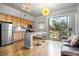 Open concept kitchen with granite countertop, light wood cabinets, and breakfast bar at 620 Glen Iris Ne Dr # 205, Atlanta, GA 30308