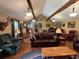 Spacious living room with hardwood floors, vaulted ceiling, and leather furniture at 410 Kilcrease Rd, Auburn, GA 30011