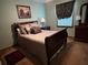 Bedroom with a sleigh bed, dresser, and window coverings at 410 Kilcrease Rd, Auburn, GA 30011