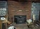 Brick fireplace in unfinished basement with wood storage at 410 Kilcrease Rd, Auburn, GA 30011
