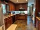 Modern kitchen with stainless steel appliances, granite countertops, and dark wood cabinets at 410 Kilcrease Rd, Auburn, GA 30011