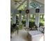 Bright sunroom with abundant windows, wicker furniture, and ample natural light at 410 Kilcrease Rd, Auburn, GA 30011