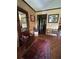 Inviting entryway with hardwood floors, antique furniture, and a large mirror at 410 Kilcrease Rd, Auburn, GA 30011