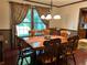 Formal dining room with hardwood floors, large table and chairs, and window views at 410 Kilcrease Rd, Auburn, GA 30011