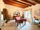 Bright dining room features a wood ceiling, large window, and table with seating for six at 881 Rockbridge Sw Rd, Lilburn, GA 30047