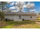 Rear view of a light beige house with a patio and yard at 105 Adrian Dr, Stockbridge, GA 30281