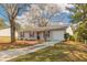 Cozy ranch home with a white exterior, black shutters, and driveway at 105 Adrian Dr, Stockbridge, GA 30281