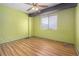 Bright bedroom with light wood flooring and ceiling fan at 112 Camelot Dr, Atlanta, GA 30349