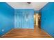 A blue bedroom with wood-look floors and built-in closet at 112 Camelot Dr, Atlanta, GA 30349