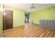 A bedroom with light-green walls, wood-look floors, and a door to a balcony at 112 Camelot Dr, Atlanta, GA 30349