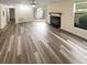 Living room with fireplace, patio access, and wood-look floors at 6383 Wedgewood Trce, Tucker, GA 30084