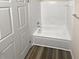 Clean bathroom with a bathtub and tiled walls at 6383 Wedgewood Trce, Tucker, GA 30084