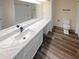 Main bathroom with a quartz vanity and wood-look floor at 6383 Wedgewood Trce, Tucker, GA 30084