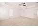 Large bedroom with carpeted floor and ensuite bathroom access at 1718 Lacebark Elm Way, Lawrenceville, GA 30045