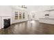 Living area with hardwood floors, fireplace, kitchen view at 1718 Lacebark Elm Way, Lawrenceville, GA 30045