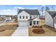 Two story house with gray brick and white accents at 1718 Lacebark Elm Way, Lawrenceville, GA 30045