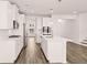 Well-equipped kitchen with white cabinets and large island at 1718 Lacebark Elm Way, Lawrenceville, GA 30045