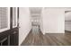 Bright entry hall with wood-look floors and view to living area at 1718 Lacebark Elm Way, Lawrenceville, GA 30045