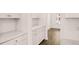 White kitchen with built-in cabinetry and pantry at 1718 Lacebark Elm Way, Lawrenceville, GA 30045