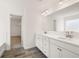 Double vanity bathroom with a large mirror and walk-in closet at 1718 Lacebark Elm Way, Lawrenceville, GA 30045
