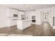 Modern kitchen boasts white cabinets, island, and stainless steel appliances at 1718 Lacebark Elm Way, Lawrenceville, GA 30045