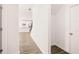 Clean hallway with wood-look floors; view of kitchen and stairs at 1718 Lacebark Elm Way, Lawrenceville, GA 30045