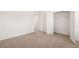 Well-lit bedroom with neutral wall paint and carpet at 1718 Lacebark Elm Way, Lawrenceville, GA 30045