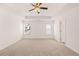 Bright bedroom featuring neutral wall colors and carpeted floors at 1718 Lacebark Elm Way, Lawrenceville, GA 30045