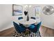Round dining table with four blue velvet chairs in a bright space at 6375 Rosetta Dr # 86, South Fulton, GA 30331