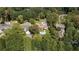 Aerial view of a neighborhood with lush trees and houses, featuring a home with a pool at 2880 Bakers Farm Se Rd, Atlanta, GA 30339