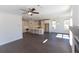 Open living room with hardwood floors and a view into the kitchen area at 709 Dodd Ln # 165, Buford, GA 30518