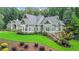 House exterior showcasing a large home, green lawn, and mature trees at 114 Trinity Hollow Dr, Canton, GA 30115