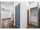 Bright hallway with hardwood floors, leading to laundry and stairs at 206 Commerce Dr, Decatur, GA 30030