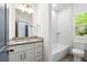 Simple bathroom with white vanity and subway tile shower at 206 Commerce Dr, Decatur, GA 30030