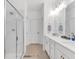 Bathroom with double vanity, white cabinets and a large walk-in shower at 205 Lakeside Pl, Canton, GA 30114