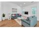 Spacious living room with hardwood floors, teal sofas, and plenty of natural light at 205 Lakeside Pl, Canton, GA 30114
