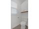 Simple powder room with white toilet and vanity, and wood-look tile floor at 205 Lakeside Pl, Canton, GA 30114