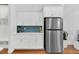 White kitchen cabinets and stainless steel refrigerator at 205 Lakeside Pl, Canton, GA 30114