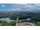 Aerial view showcasing home's location near a lake and wooded area at 205 Lakeside Pl, Canton, GA 30114