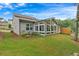 Gray house exterior with a sunroom and landscaping. Situated on a grassy lot at 205 Lakeside Pl, Canton, GA 30114