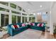 Sunroom with teal sofas and abundant natural light at 205 Lakeside Pl, Canton, GA 30114