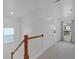 Upstairs hallway with wood railing, carpet, and natural light at 205 Lakeside Pl, Canton, GA 30114
